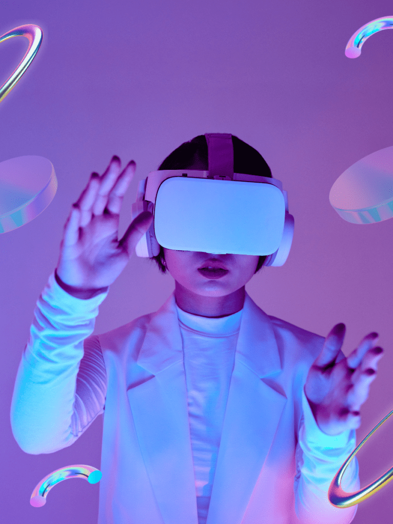 A person wearing a VR headset interacts with a virtual environment, surrounded by futuristic, glowing shapes. The scene represents the immersive experience of the metaverse. The image is used to convey the concept of digital innovation, highlighting Vertech Digital's focus on the future of virtual spaces and technology.






